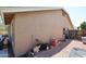 Simple side yard with lawn care items stored next to the house at 6352 W Campo Bello Dr, Glendale, AZ 85308