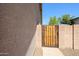 Rustic gate in stucco wall provides secure access to the side yard at 6352 W Campo Bello Dr, Glendale, AZ 85308