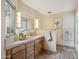 Bathroom with marble sink, natural wood cabinets, and decorative vanity lighting at 6411 S River Dr # 10, Tempe, AZ 85283