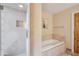 Bathroom boasts travertine shower and soaking tub, blending modern style and relaxation at 6411 S River Dr # 10, Tempe, AZ 85283