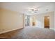 Large bedroom with neutral walls, carpet floors, and a ceiling fan at 6411 S River Dr # 10, Tempe, AZ 85283