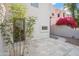 Charming courtyard with desert landscaping and a stone tile patio near a tan building and bright flowers at 6411 S River Dr # 10, Tempe, AZ 85283