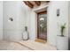 Charming home entrance with a glass door, stone flooring, potted plants, and stylish exterior lighting at 6411 S River Dr # 10, Tempe, AZ 85283