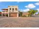 Stunning two-story home featuring a private garage, desert landscaping, and unique architecture under a bright blue sky at 6411 S River Dr # 10, Tempe, AZ 85283