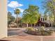 Beautiful front view of the property with mature trees and a stone fountain at 6411 S River Dr # 10, Tempe, AZ 85283