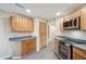 Kitchen with stainless steel oven, microwave, and light wood cabinets at 6411 S River Dr # 10, Tempe, AZ 85283