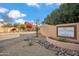 Beautiful street view of the Cottonwoods of Anozira community sign, trees and landscaped yard at 6411 S River Dr # 10, Tempe, AZ 85283