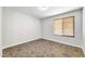 Bright bedroom with tile floors and window blinds at 6427 W Turquoise Ave, Glendale, AZ 85302