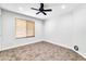 Well-lit bedroom featuring tile floors and ceiling fan at 6427 W Turquoise Ave, Glendale, AZ 85302