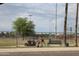 Gathering enjoying a park with benches, shade structures, and a basketball court at 6427 W Turquoise Ave, Glendale, AZ 85302