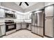 Modern kitchen with stainless steel appliances and granite countertops at 6427 W Turquoise Ave, Glendale, AZ 85302