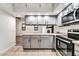 Modern kitchen featuring stainless steel appliances and granite countertops at 6427 W Turquoise Ave, Glendale, AZ 85302