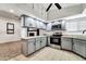 Updated kitchen with stainless steel appliances and gray cabinets at 6427 W Turquoise Ave, Glendale, AZ 85302