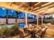 Covered patio with dining table, ceiling fan, and view of the pool at 6943 E Sheena Dr, Scottsdale, AZ 85254