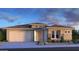 Single-story home with a three-car garage and desert landscaping at 8818 W Denton Ln, Glendale, AZ 85305