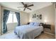 Bedroom with full-size bed and ceiling fan at 10778 W Cambridge Ave, Avondale, AZ 85392