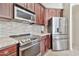 Well-equipped kitchen with granite counters and stainless steel appliances at 11000 N 77Th Pl # 1004, Scottsdale, AZ 85260