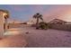 Landscaped backyard with gravel and brick patio at 11623 W Lemon Ct, Surprise, AZ 85378