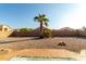 Gravel backyard with palm trees and a patio at 11623 W Lemon Ct, Surprise, AZ 85378