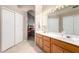 Main bathroom with double vanity and access to bedroom at 11623 W Lemon Ct, Surprise, AZ 85378