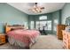 Spacious bedroom with ceiling fan and large windows at 11623 W Lemon Ct, Surprise, AZ 85378