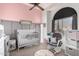 Bedroom with crib, rocker, and large window at 11623 W Lemon Ct, Surprise, AZ 85378