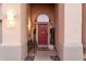 Inviting entryway with red door and decorative accents at 11623 W Lemon Ct, Surprise, AZ 85378