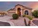 Single-story home with arched entryway and neutral colors at 11623 W Lemon Ct, Surprise, AZ 85378