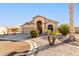 One-story house with a red door and desert landscaping at 11623 W Lemon Ct, Surprise, AZ 85378