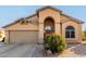 Single-story home with arched entryway and neutral colors at 11623 W Lemon Ct, Surprise, AZ 85378