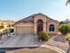 Single-story home with a two-car garage and desert landscaping at 11623 W Lemon Ct, Surprise, AZ 85378