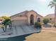Single-story home with a two-car garage and desert landscaping at 11623 W Lemon Ct, Surprise, AZ 85378