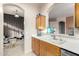 Kitchen with wood cabinets, double sink, and views to Gathering room at 11623 W Lemon Ct, Surprise, AZ 85378