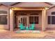 Relaxing patio area with teal chairs and brick flooring at 11623 W Lemon Ct, Surprise, AZ 85378