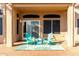 Patio with green chairs and a small table at 11623 W Lemon Ct, Surprise, AZ 85378