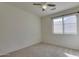 Bright bedroom with ceiling fan, window coverings, and carpet flooring at 12740 S 175Th Dr, Goodyear, AZ 85338