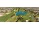 Aerial view of a golf course with a pond and residential homes in the background at 13265 W Countryside Dr, Sun City West, AZ 85375