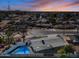 Aerial view of a single story home with a pool at sunset at 1344 E Ellis Cir, Mesa, AZ 85203