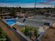 Aerial view of single story home with pool at dusk at 1344 E Ellis Cir, Mesa, AZ 85203