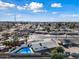 Aerial view showcasing a single story home with pool and surrounding area at 1344 E Ellis Cir, Mesa, AZ 85203