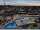 Aerial view of single story home with pool at sunset at 1344 E Ellis Cir, Mesa, AZ 85203