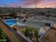 Aerial view of a single-story home with a pool at dusk at 1344 E Ellis Cir, Mesa, AZ 85203