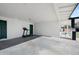 Attached garage with ample space for storage and a treadmill at 1344 E Ellis Cir, Mesa, AZ 85203