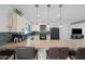 Modern kitchen with granite countertops and green tile backsplash at 1344 E Ellis Cir, Mesa, AZ 85203