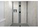 Walk-in shower with stylish tile and built-in shelving at 1344 E Ellis Cir, Mesa, AZ 85203