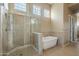 Elegant bathroom with a glass-enclosed shower and freestanding soaking tub with tile surround at 15836 E Brittlebush Ln, Fountain Hills, AZ 85268