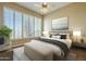 Cozy bedroom featuring large windows, plantation shutters, ceiling fan, and neutral decor for a calming retreat at 15836 E Brittlebush Ln, Fountain Hills, AZ 85268