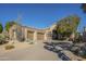 Spacious home featuring a three-car garage, desert landscaping, and a curved driveway at 15836 E Brittlebush Ln, Fountain Hills, AZ 85268