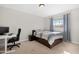 Bedroom with a twin bed, desk, and window with curtains at 1710 E 1St St, Mesa, AZ 85203