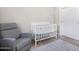 Bedroom with crib and recliner chair at 1710 E 1St St, Mesa, AZ 85203